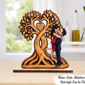 May include: A wooden decorative sculpture featuring a stylized tree with intertwined trunks forming a heart shape. A couple is kissing in front of the tree. The names Noah and Nick are engraved on the trunks, and the date 14.02.2020 is on a heart.