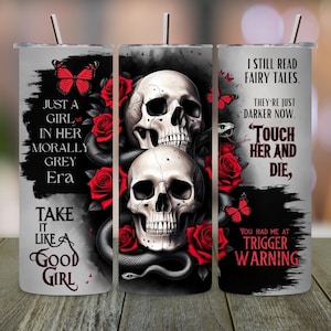 May include: A stainless steel tumbler with a dark gothic design. The design features two skulls, red roses, snakes, and butterflies. Text includes "Just a Girl in Her Morally Grey Era" and "I Still Read Fairy Tales."