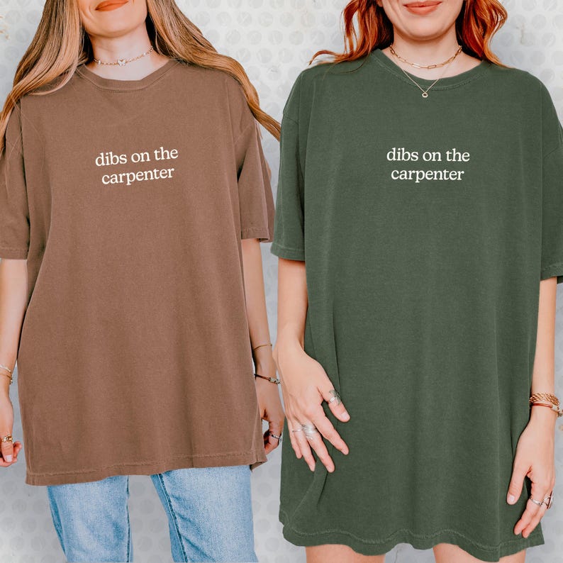 Two women wearing t-shirts with the same text printed on them.