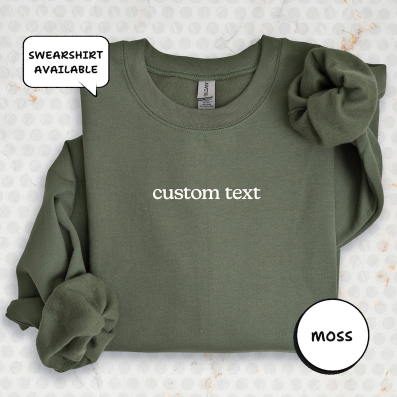 A green sweatshirt with the text "custom text" printed on it, along with a speech bubble indicating that the sweatshirt is available for purchase.