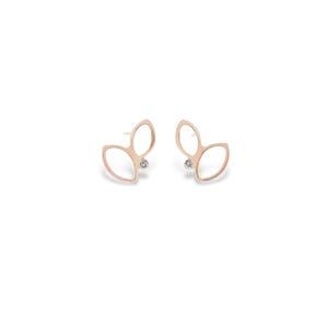 May include: A pair of rose gold stud earrings. Each earring has an openwork design, resembling two overlapping leaves. A small, clear gemstone is set in the centre of each earring. The earrings are displayed against a white background, highlighting their delicate design.
