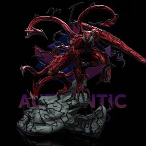 May include: A red and black Carnage statue. The figure is crouched on a gray stone base with black tendrils. The statue has a detailed texture and dynamic pose, with multiple red tendrils extending from the back.