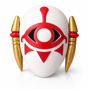 May include: A white mask with a red eye design and gold accents. The mask features a central eye symbol and red triangles. Gold, spear-like elements are on each side. A decorative item.