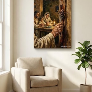 May include: A framed painting with a family scene in warm tones. The artwork shows a family gathered around a table, lit by a lantern. A hand reaches towards the door, holding a bundle of flowers. The painting is displayed on a wall above a beige armchair.