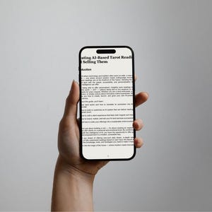 May include: A black smartphone displays text: "ating AI-Based Tarot Readings & Selling Them." The phone is held in a hand against a neutral background. The screen shows multiple lines of text, suggesting an e-book or article.