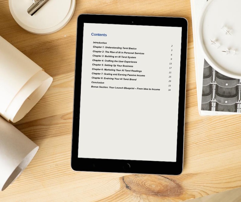 May include: A black tablet displays a document titled "Contents" with a list of chapters about tarot and AI. The tablet is on a light wooden surface, with rolled paper and a white circular object with pins nearby. The text includes chapter titles like "Understanding Tarot Basics."