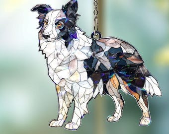 May include: A decorative hanging ornament featuring a Border Collie dog design. The dog is depicted in a mosaic style with black, white, and iridescent accents. It hangs from a silver chain, perfect for adding a touch of canine charm to any space.