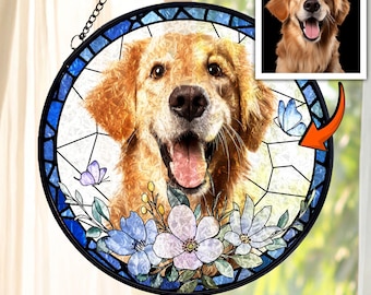 May include: A round stained glass window featuring a Golden Retriever dog with a happy expression. The window has a blue border with floral and butterfly accents. A smaller image of the dog is in the upper right corner.