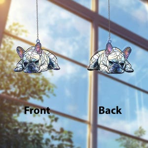 May include: Two hanging French bulldog ornaments. Each ornament is a stylized depiction of a French bulldog in a resting pose, with a stained-glass effect. The front and back of the ornament are visible, with the words "Front" and "Back" displayed.