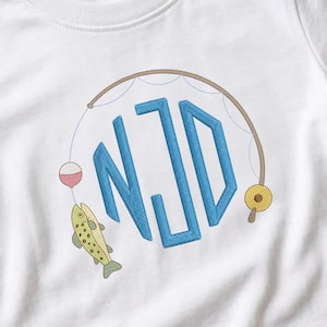 May include: A white short-sleeved t-shirt featuring an embroidered design of a fishing rod curving over the blue monogram letters NJD. The design includes a yellow fishing reel, a red and white bobber, and a green speckled fish hanging below.