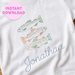 May include: A white t-shirt featuring an embroidered design of three fish in green, orange, and gold outlines with spotted details. Below the fish, the name Jonathan is embroidered in a dark blue cursive font. A pink circle with text reads INSTANT DOWNLOAD.