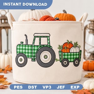 May include: A cream-colored fabric storage basket featuring an embroidered green and white gingham tractor pulling a trailer filled with orange and white pumpkins. The basket has two side handles and the text PES, DST, VP3, JEF, EXP at the bottom.