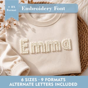 May include: A beige crewneck sweatshirt featuring the name Emma embroidered in a textured, cream-colored font. The image includes text overlays stating + BX Format, Embroidery Font, 6 SIZES, 9 FORMATS, and ALTERNATE LETTERS INCLUDED.