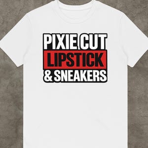 May include: White t-shirt with the text "PIXIE CUT LIPSTICK & SNEAKERS" in black and red block letters. The text is stacked in three lines, with the words "LIPSTICK" and "& SNEAKERS" on a red background.