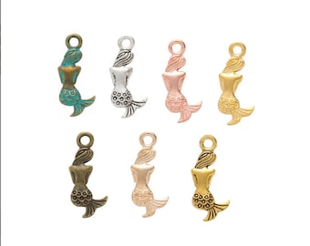 May include: Six mermaid charm pendants in different colors: turquoise, silver, rose gold, gold, bronze, and copper. Each charm features a detailed mermaid design with a flowing tail.