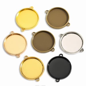 May include: A collection of seven round bezel trays in various metallic finishes, including gold, bronze, and silver. Each tray has a circular interior and two small loops for attaching to other components. The trays are designed for jewelry making and crafting.