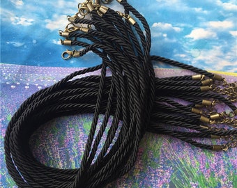 May include: A bulk pack of 20 black braided cords with gold-toned lobster clasps. The cords are approximately 18 inches long and are perfect for making necklaces, bracelets, or keychains.