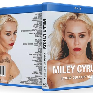 May include: A blue Blu-ray case featuring Miley Cyrus. The cover shows a close-up of Cyrus with red lipstick and blonde hair. The text "MILEY CYRUS VIDEO COLLECTION" is displayed. The back of the case lists song titles and a barcode.