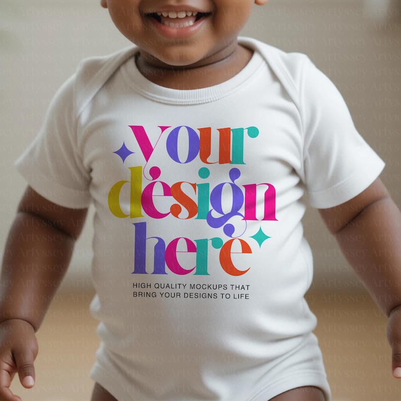 May include: A white baby onesie with the text "Your design here" in colorful, stylized lettering. The text is accompanied by the phrase "High quality mockups that bring your designs to life."