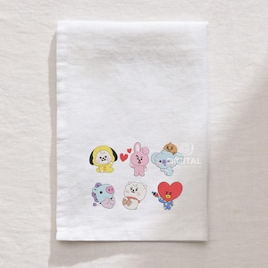 May include: White rectangular towel featuring embroidered cartoon characters in various colors. The characters include a yellow chick, a pink bunny, a blue koala, a purple horse, a white bear, and a red heart-shaped figure. The towel is made of a soft, absorbent material.