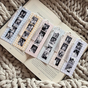 May include: Six rectangular bookmarks with a gingham pattern in blue, yellow, pink, green, and purple. Each bookmark features a vertical strip of four black and white photographs and is finished with a white tassel attached to the top.