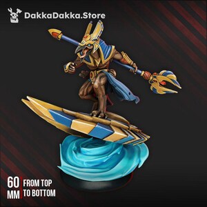 May include: A detailed figurine of an Anubis-like figure riding a surfboard. The figure is brown, gold, and blue, holding a staff. The surfboard is gold and blue, atop a blue wave base. The text on the image reads "60 mm from top to bottom."