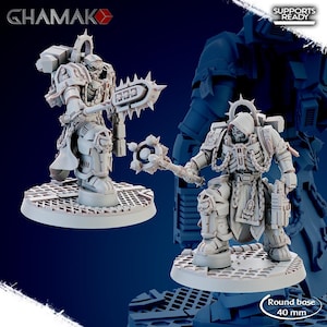 May include: Two light gray resin miniature figures on 40 mm round bases. One figure holds a spiked chain weapon, the other a mace. Both wear hooded armor with skeletal chest details, chains, and backpacks. Text includes GHAMAK and SUPPORTS READY.