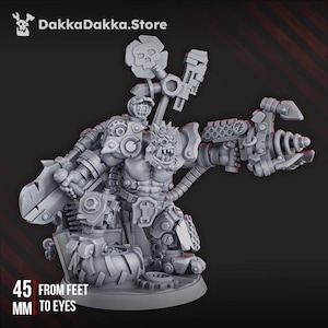 May include: A gray, detailed miniature figure of a muscular, orc-like character with mechanical enhancements. The figure is holding a large weapon and has a skull emblem. The text "45 MM FROM FEET TO EYES" is visible. The DakkaDakka.Store logo is in the top left.