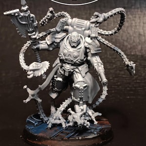 May include: A gray miniature figure of a futuristic warrior, holding a large axe-like weapon. The figure is highly detailed with mechanical elements and tubing. The base is a dark color with blue and brown accents. The text "ATLAN FORGE" is at the top.