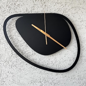 Black unique wall clock perfect for stylish interior spaces