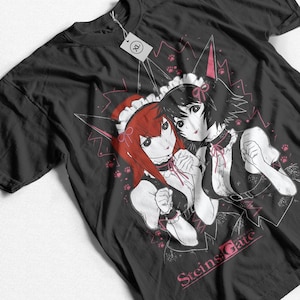 May include: Black t-shirt featuring an anime-style illustration of two women in maid outfits with red and black hair. The design includes pink accents, paw prints, and the text "Steins Gate".
