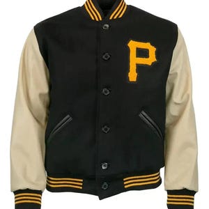 May include: Black varsity jacket with tan sleeves and a yellow "P" patch. The jacket features a black body, tan sleeves, and yellow and black striped trim on the collar, cuffs, and hem. It has a button-up front and two front pockets.