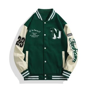 May include: Green varsity jacket with cream-colored sleeves. Features the number "23" on one sleeve and the word "Fordream" on the other. The jacket has white stripes on the collar, cuffs, and hem, and the letter "N" on the chest. Text on the jacket reads "All to Oneself".