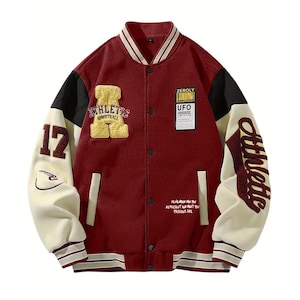 May include: Maroon and cream varsity jacket with black detailing. Includes embroidered patches with the words "ATHLETIC STREETBALL" and "UFO". The sleeves have the word "Athletic" and the number "17".