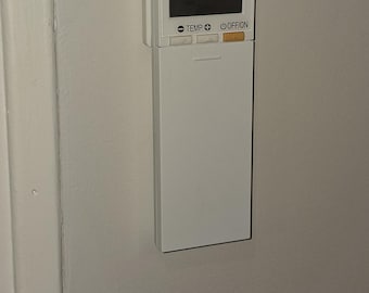 Wall mount for Mitsubishi-compatible air conditioner remote control.