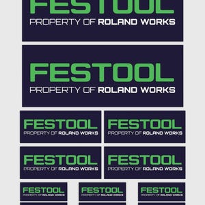 May include: A series of rectangular stickers displaying the word "FESTOOL" in green, with "PROPERTY OF ROLAND WORKS" in white text underneath. The stickers are set against a dark blue backdrop. The image shows multiple sizes of the same design.