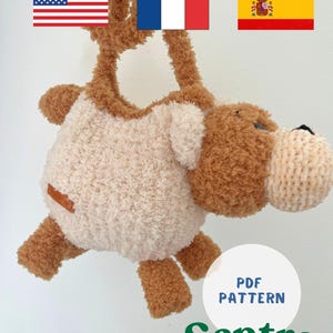 May include: A plush, handmade stuffed animal in the shape of a hippo, with a light beige body and brown accents. The hippo has a textured, fluffy appearance and a small brown patch. The text "PDF PATTERN" and "Sentro" are visible.