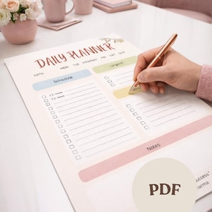 May include: A daily planner with the words "Daily Planner" in a script font. The planner has sections for scheduling, urgent tasks, and notes. A hand is holding a pen, ready to write on the planner.