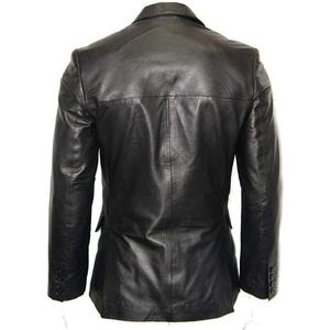 May include: Black leather blazer with a notched lapel, three-button cuffs, and a two-button closure. The back of the jacket features a center vent and a tailored fit. The jacket is made of a smooth, supple leather.
