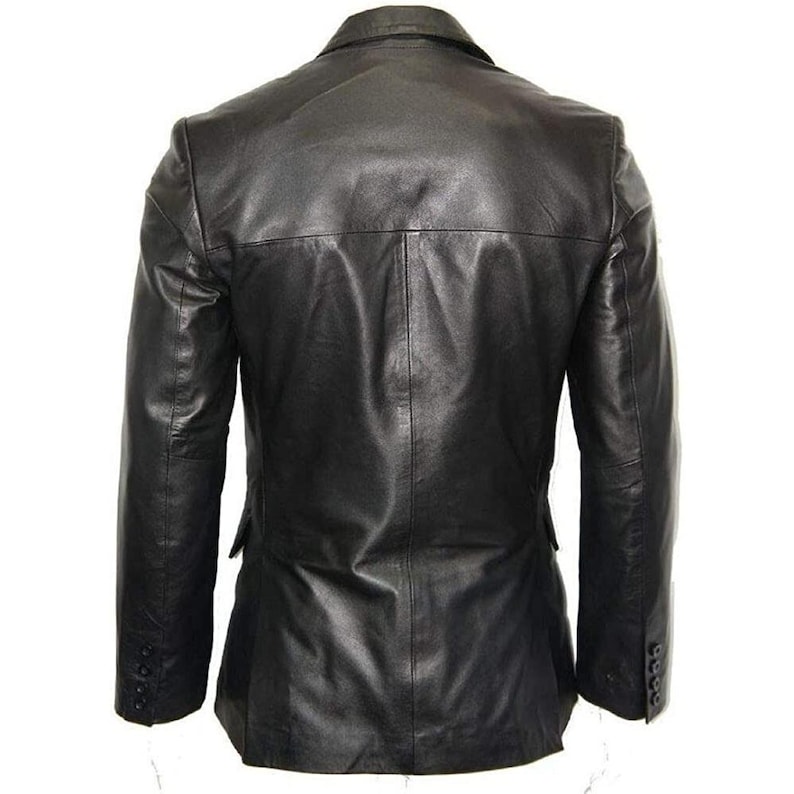May include: Black leather blazer with a notched lapel, three-button cuffs, and a two-button closure. The back of the jacket features a center vent and a tailored fit. The jacket is made of a smooth, supple leather.