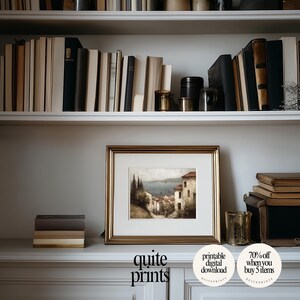 Framed printable Tuscan Countryside Oil Painting artwork in a little frame near a bookshelf | Digital download wall art with Soft tones | Vintage Vintage house poster print