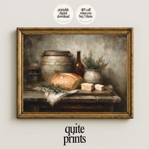 May include: A framed still life print featuring a rustic scene with a loaf of bread, butter, a bottle, and a metal container. The artwork has a vintage aesthetic with a warm color palette and the text "quite prints".