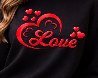May include: Black sweatshirt with a red "Love" design. The design features a large heart shape with the word "Love" in a cursive font, along with several smaller hearts. The sweatshirt is a solid black color.