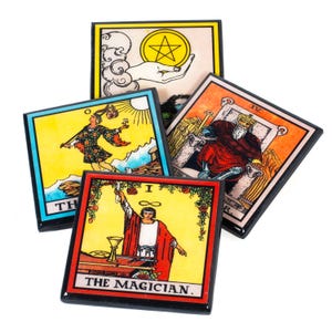 May include: A collection of square tarot cards featuring colorful illustrations and black borders. The cards depict various scenes, including a hand holding a pentacle, a figure with a staff, and a robed figure labeled "THE MAGICIAN."