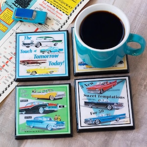 May include: Four square coasters with vintage car designs and the text "The Touch of Tomorrow Today!" and "3 New Sweet Temptations For 59". A teal mug filled with coffee sits on one coaster. A toy car and map are also present.