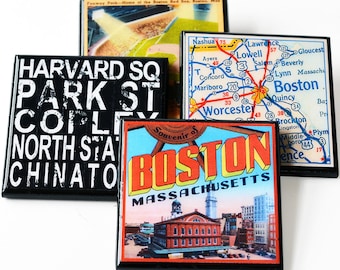 May include: Four vintage-style magnets featuring different designs related to Boston, Massachusetts. The first magnet is black with white text that reads "HARVARD SQ PARK ST COPLEY NORTH STATION CHINATOWN". The second magnet is a blue, red, and yellow souvenir magnet with the text "Souvenir of BOSTON MASSACHUSETTS". The third magnet is a map of the Boston area with the text "Nashua, Lowell, Lawrence, Salem, Beverly, Lynn, Boston, Quincy, Brockton, Middleboro, Plymouth, Providence". The fourth magnet is a colorful image of the Boston skyline with the text "Boston, Massachusetts".