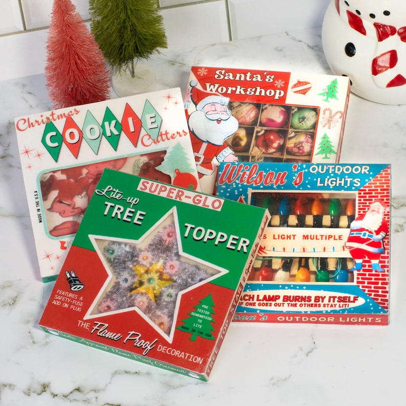 May include: A collection of vintage Christmas decorations, including boxes of cookie cutters, tree toppers, and outdoor lights. The boxes feature festive designs with Santa Claus and Christmas tree illustrations. The color palette includes red, green, and white.