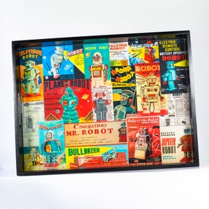 May include: A wooden tray featuring a collage of vintage robot illustrations. The tray showcases a variety of robots in different poses and designs, with text that reads "Television Robot", "Planet Robot", "Radar Robot", "Cragstan's Mr. Robot", "Robert the Robot", and "Jupiter Robot".