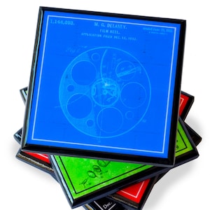 May include: A stack of four coasters in blue, green, red and black with a vintage blueprint design of a film reel. The top coaster has the text "1,144,693. M.G. DELANEY. FILM REEL. APPLICATION FILED DEC. 12, 1912.  Patented June 20, 1915."