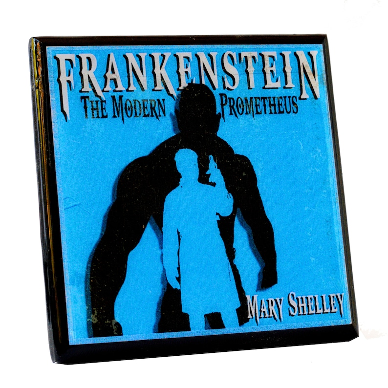 May include: Square pin featuring the title "FRANKENSTEIN The Modern Prometheus" with a silhouette of a figure holding a gun, and a muscular figure in black on a blue background. The author's name, Mary Shelley, is also displayed.